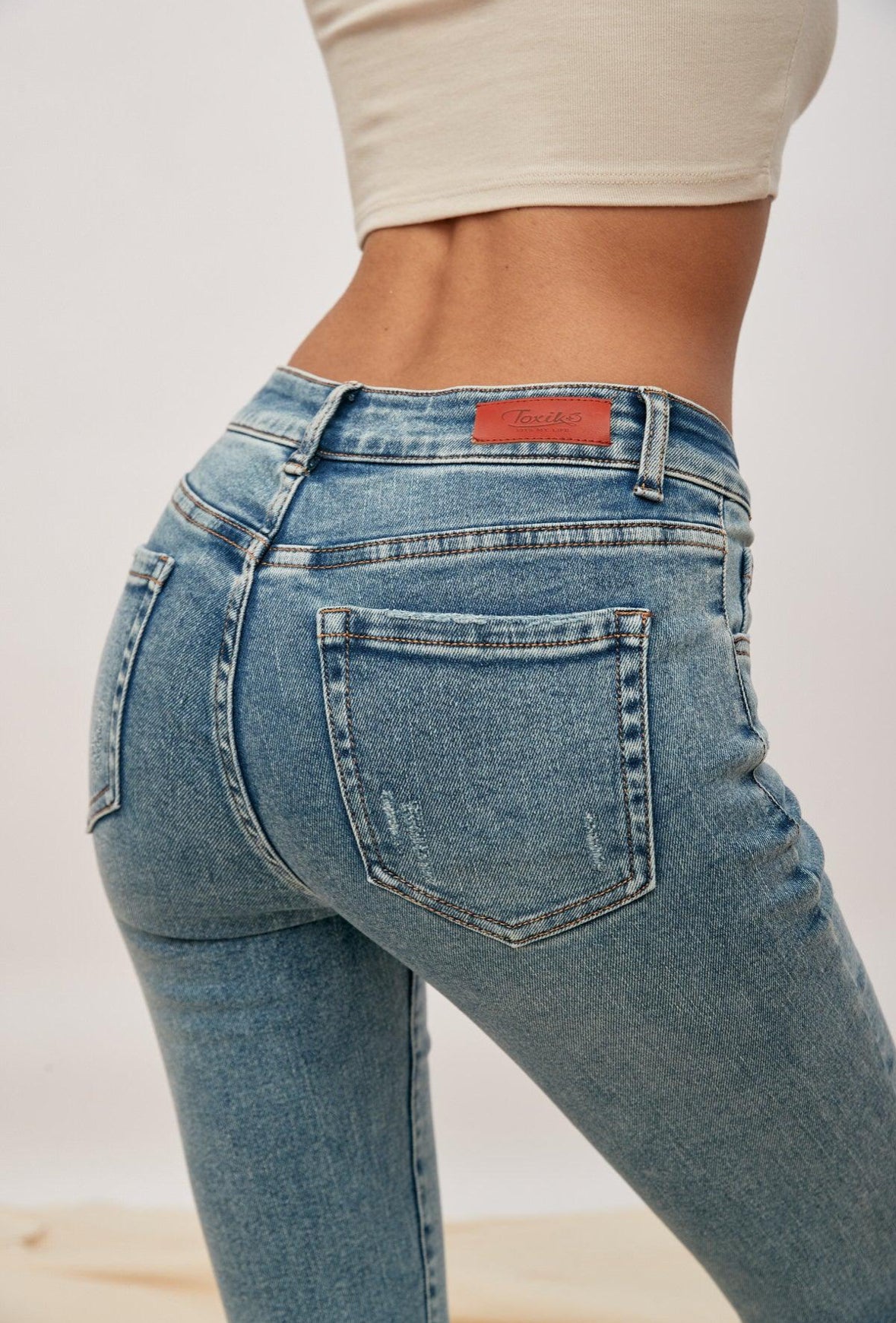 TOXIK Slim fit high waisted distressed jeans.